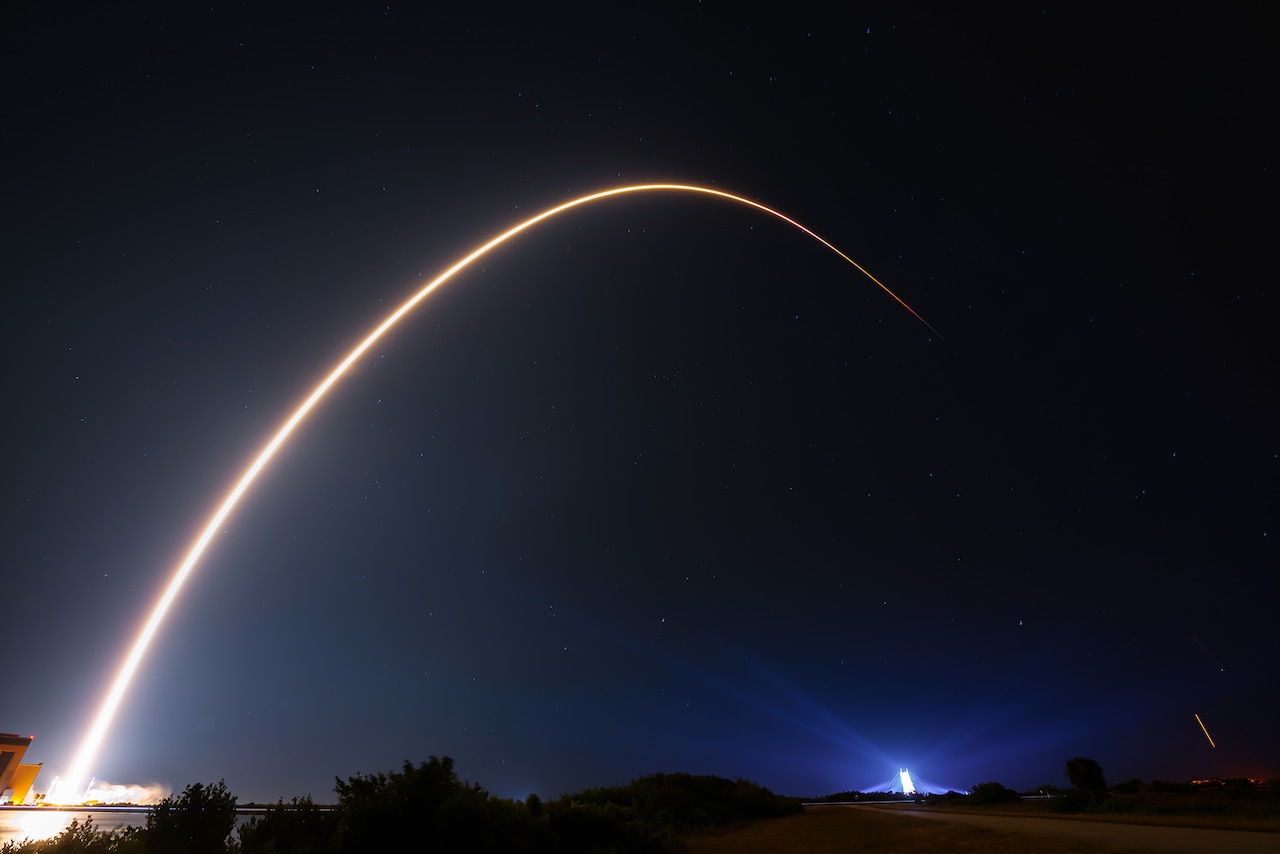A rocket launches into the night sky.