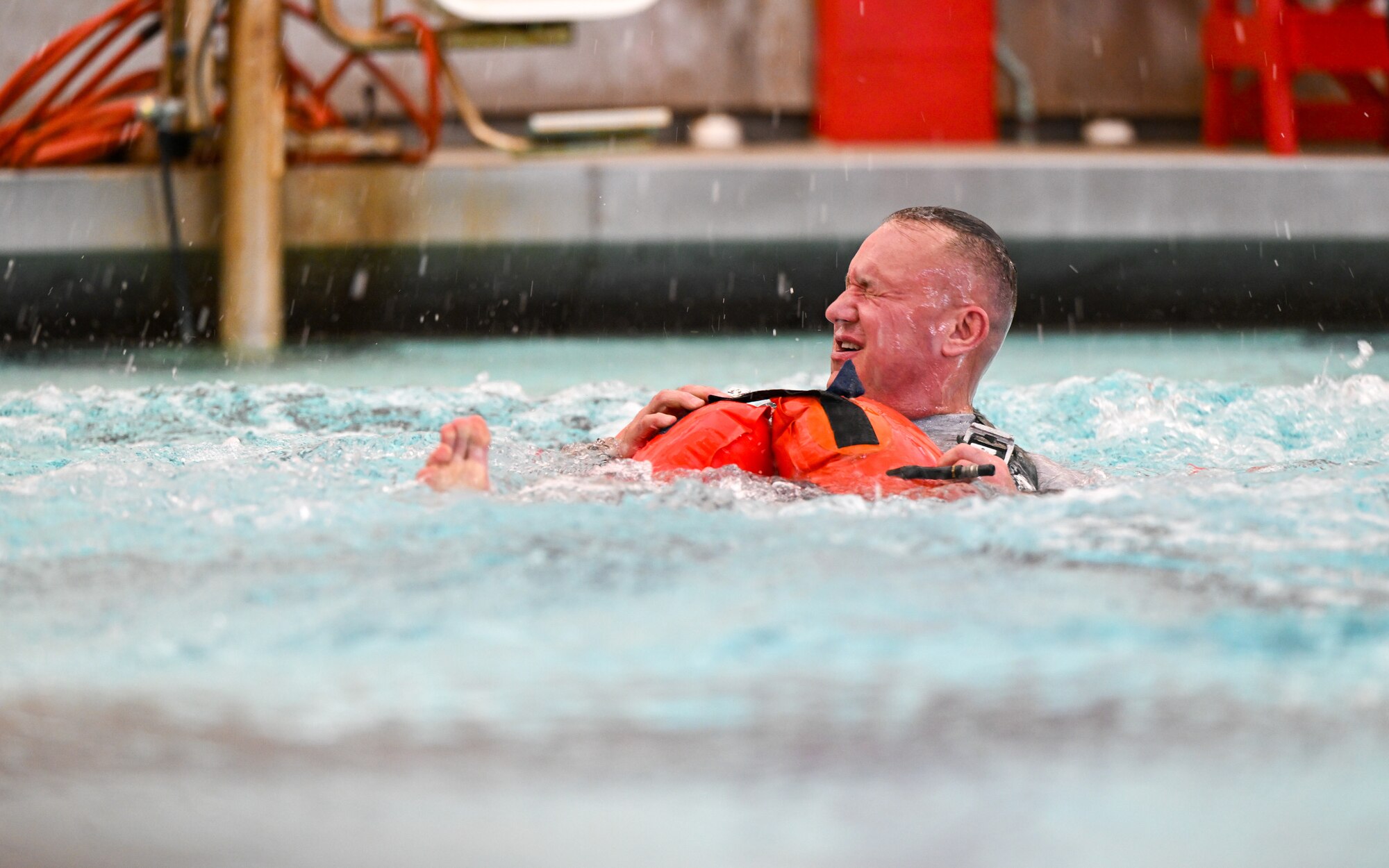 Lt. Col. Drew Tancer, the operations planner with the 910th Operations Support Squadron, recovers after unlatching himself from the parachute cord pulling him through the water during water survival training on April 7, 2024, at Youngstown State University, Ohio.