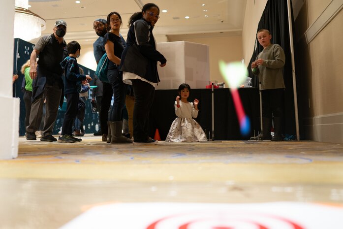 A young student launches her self-built miniature rocket models to test design and mechanics at the FIRE Rocket Challenge booth during the Sea-Air-Space Science, Technology, Engineering, and Math (STEM) expo at the Gaylord National Hotel and Conference Center, Sunday. FIRE Rocket Challenge provides STEM education programming to traditionally underrepresented and under-resourced youth. FIRE Rocket partnered with the U.S. Navy's Strategic Systems Programs (SSP) to connect STEM activities to elements of the real-world missions of commands like SSP, the Navy command that is responsible for the cradle-to-grave lifecycle of the submarine-launched ballistic missile system.