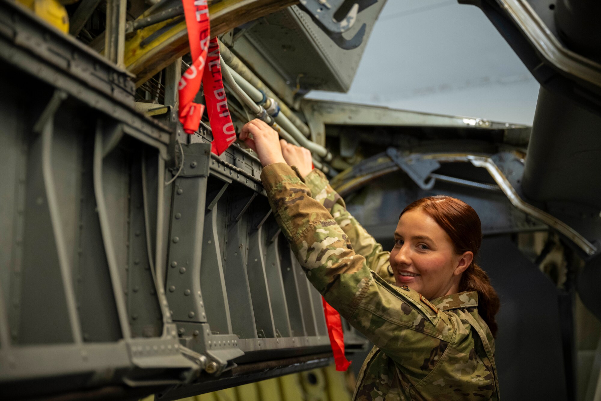 Airman 1st Class Julia Hall, 22nd Maintenance Squadron repair and reclamation apprentice, poses for at McConnell Air Force Base, Kansas, March 12, 2024. Hall was a part of a volunteer team on the project to fix 'Doc', the B-29 bomber. (U.S. Air Force photo by Airman Paula Arce)