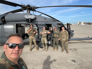The 101st Rescue Squadron members, assigned to the 106th Rescue Wing of the New York Air National Guard, pose for a picture in front of a HH-60 Pave Hawk helicopter at a combat search and rescue competition at Avon Park Air Force Range, Florida, Nov. 7, 2023. The Airmen won the Top Squadron award for the skills-based competition, which brough together combat search and rescue squadrons from around the world. (U.S. Air Force Courtesy Photo)