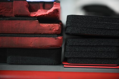 A group of old and new foam toolbox inserts sit side by side