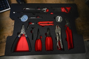 A set of tools sits inside a newly cut foam insert