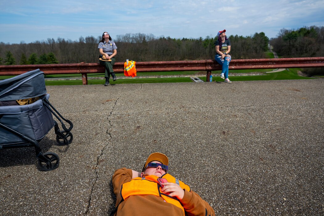 A total solar eclipse shines in the sky viewed from the Michael J. Kirwan Dam in Ravenna, Ohio, April 8, 2024.