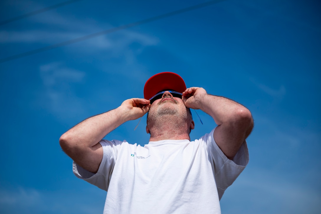 A total solar eclipse shines in the sky viewed from the Michael J. Kirwan Dam in Ravenna, Ohio, April 8, 2024.