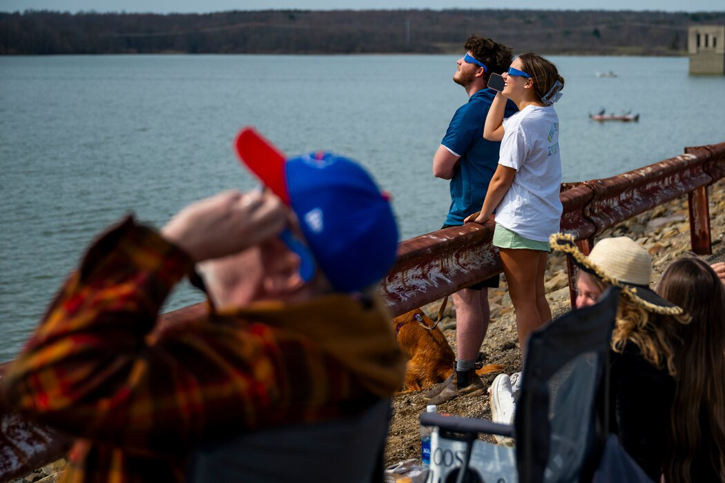 A total solar eclipse shines in the sky viewed from the Michael J. Kirwan Dam in Ravenna, Ohio, April 8, 2024.