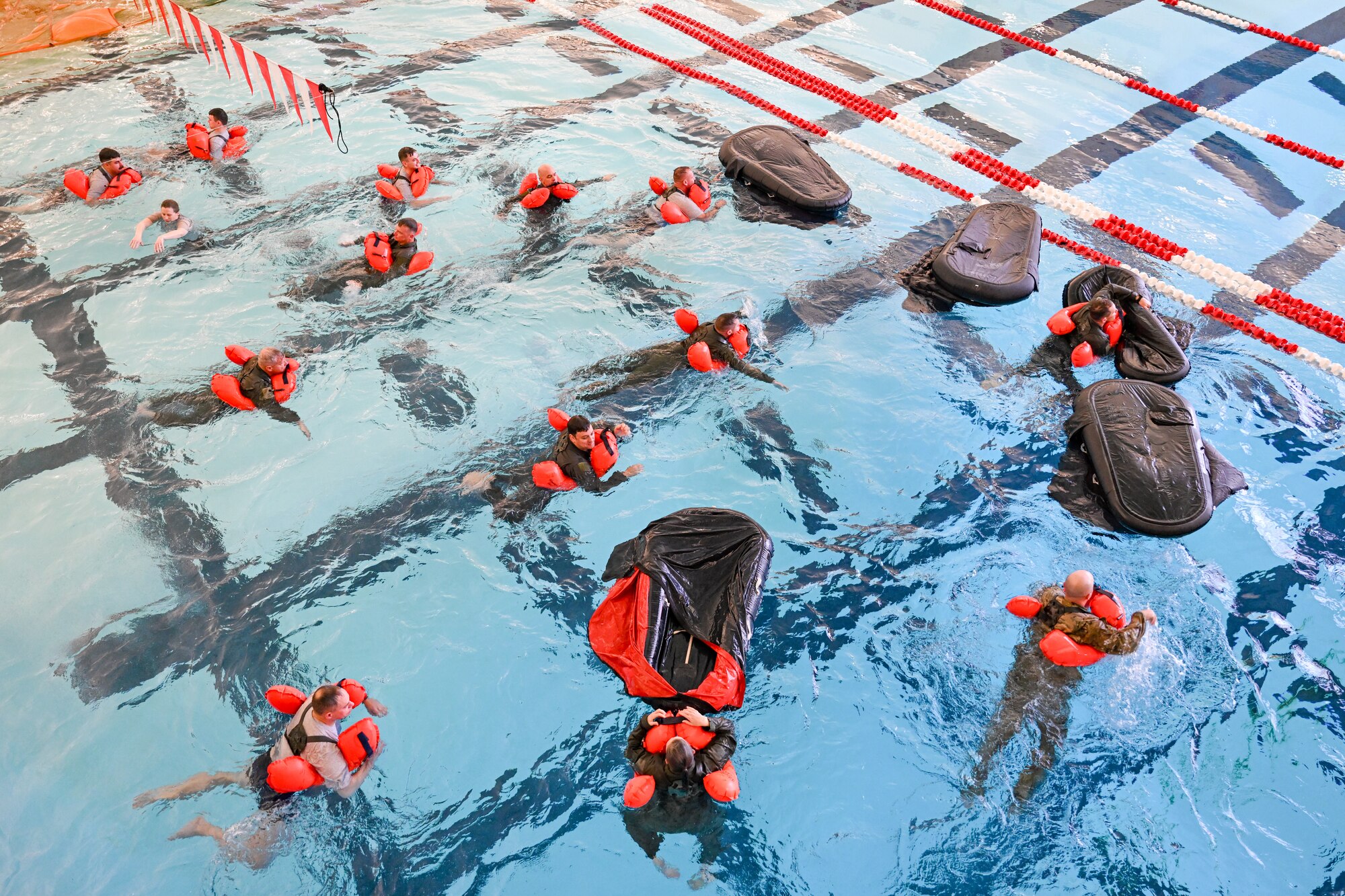 Reserve Citizen Airmen assigned to the 910th Operations Group swim toward one-person life rafts during water survival training on April 7, 2024, at Youngstown State University, Ohio.