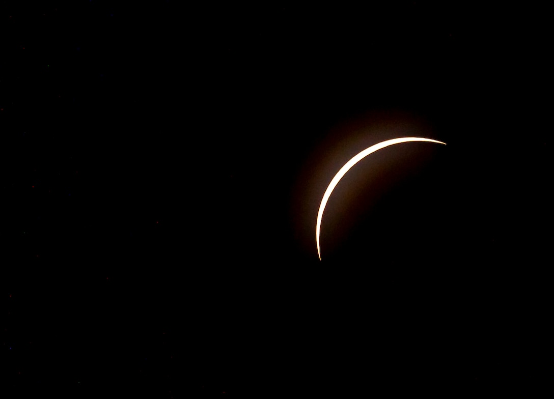 A total solar eclipse shines in the sky viewed from the Michael J. Kirwan Dam in Ravenna, Ohio, April 8, 2024.