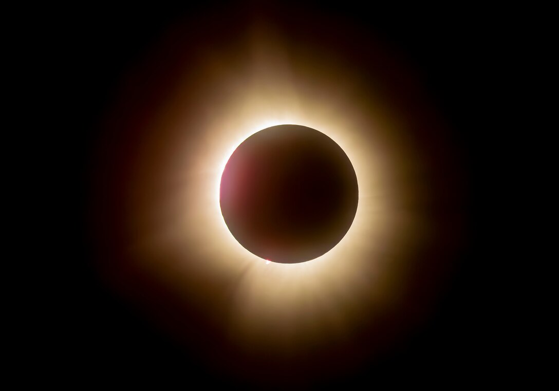 A total solar eclipse shines in the sky viewed from the Michael J. Kirwan Dam in Ravenna, Ohio, April 8, 2024.
