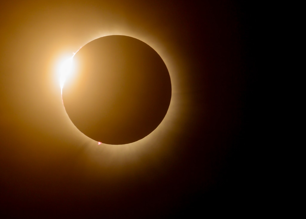 A total solar eclipse shines in the sky viewed from the Michael J. Kirwan Dam in Ravenna, Ohio, April 8, 2024.