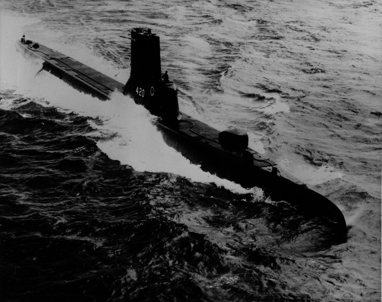 A submarine moves on the surface of the water.