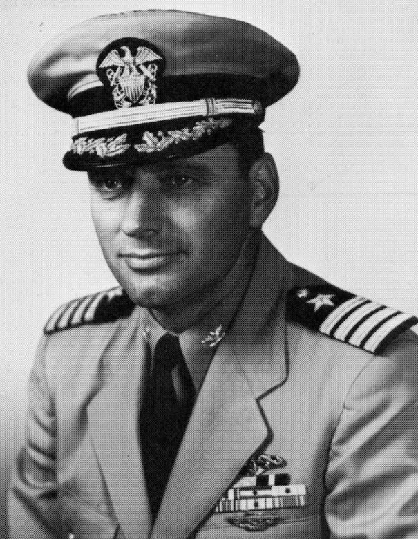 A man in uniform and cap poses for a photo.