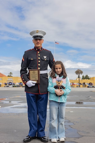 U.S. Marine Corps Pfc. Giorgi Agadjanov, a new marine with Hotel Company, 2nd Recruit Training Battalion, poses for a photograph with his niece following his graduation ceremony at Marine Corps Recruit Depot San Diego, California, April 5, 2024. Graduation took place at the completion of the 13- week transformation, which included training for drill, marksmanship, basic combat skills, and Marine Corps customs and traditions. (U.S. Marine Corps photo by Lance Cpl. Janell B. Alvarez)