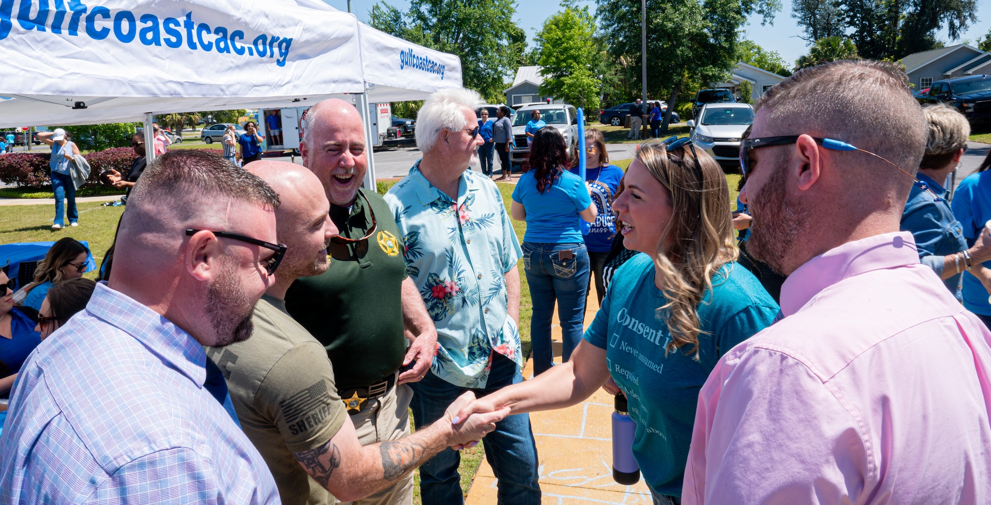 Sexual Assault Prevention and Response advocates greet Bay County Sheriff's Office deputies during the Gulf Coast Sexual Assault Prevention Bonded by Blue event at the Gulf Coast Children’s Advocacy Center