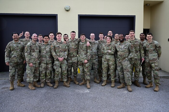 Military members stand in a group.