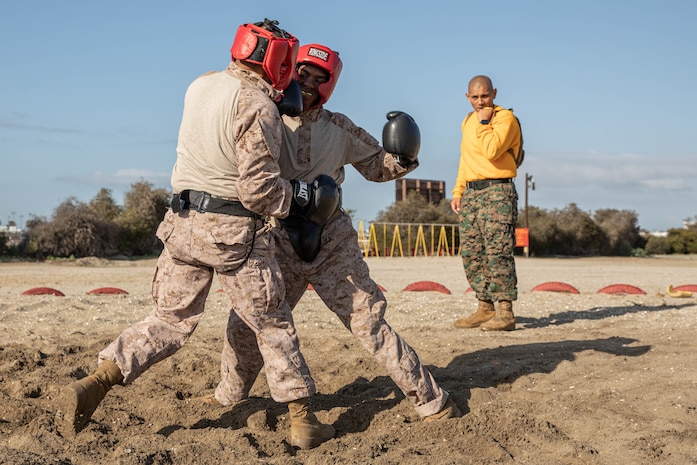 U.S. Marine Corps Staff Sgt. Kevin Mendoza, a drill instructor with Fox Company, 2nd Recruit Training Battalion, observes recruits body sparring at Marine Corps Recruit Depot San Diego, California, April 8, 2024. Recruits are taught Marine Corps Martial Arts Program techniques that instill basic self-defense that they will execute throughout recruit training during events like body sparring and pugil sticks to help build a warrior ethos and esprit de corps. (U.S. Marine Corps photo by Cpl. Sarah M. Grawcock)