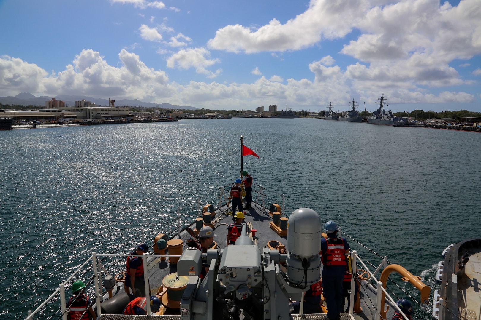 U.S. Coast Guard Cutter Harriet Lane (WMEC 903) crew renders honors to the Battleship Missouri Memorial as the Harriet Lane and crew return to home port in Pearl Harbor, Hawaii, April 9, 2024. Harriet Lane and crew departed Pearl Harbor in January and traveled more than 15,000 nautical miles spanning from the Hawaiian Islands to the east coast of Australia. Patrolling in support of Operation Blue Pacific, the cutter and crew worked alongside Pacific Island nations to forge and advance relationships with like-minded allies and partners who share a common vision for maritime governance. (U.S. Coast Guard photo by Senior Chief Petty Officer Charly Tautfest)