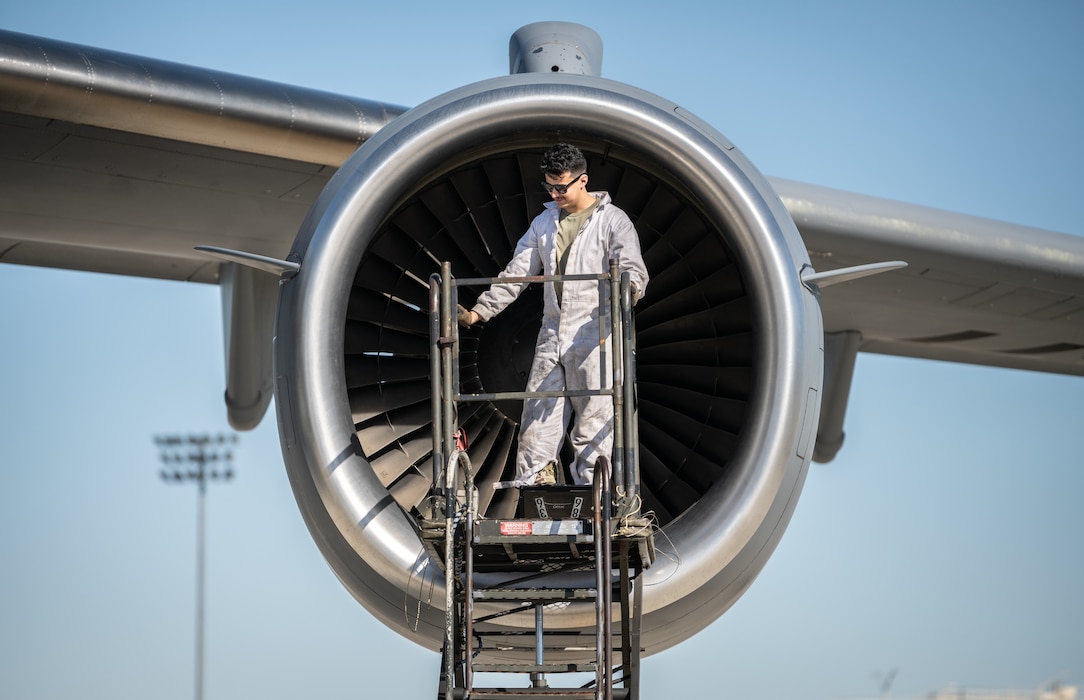 A maintenance Airmen performs routine maintenance on a C-17 Globemaster III engine