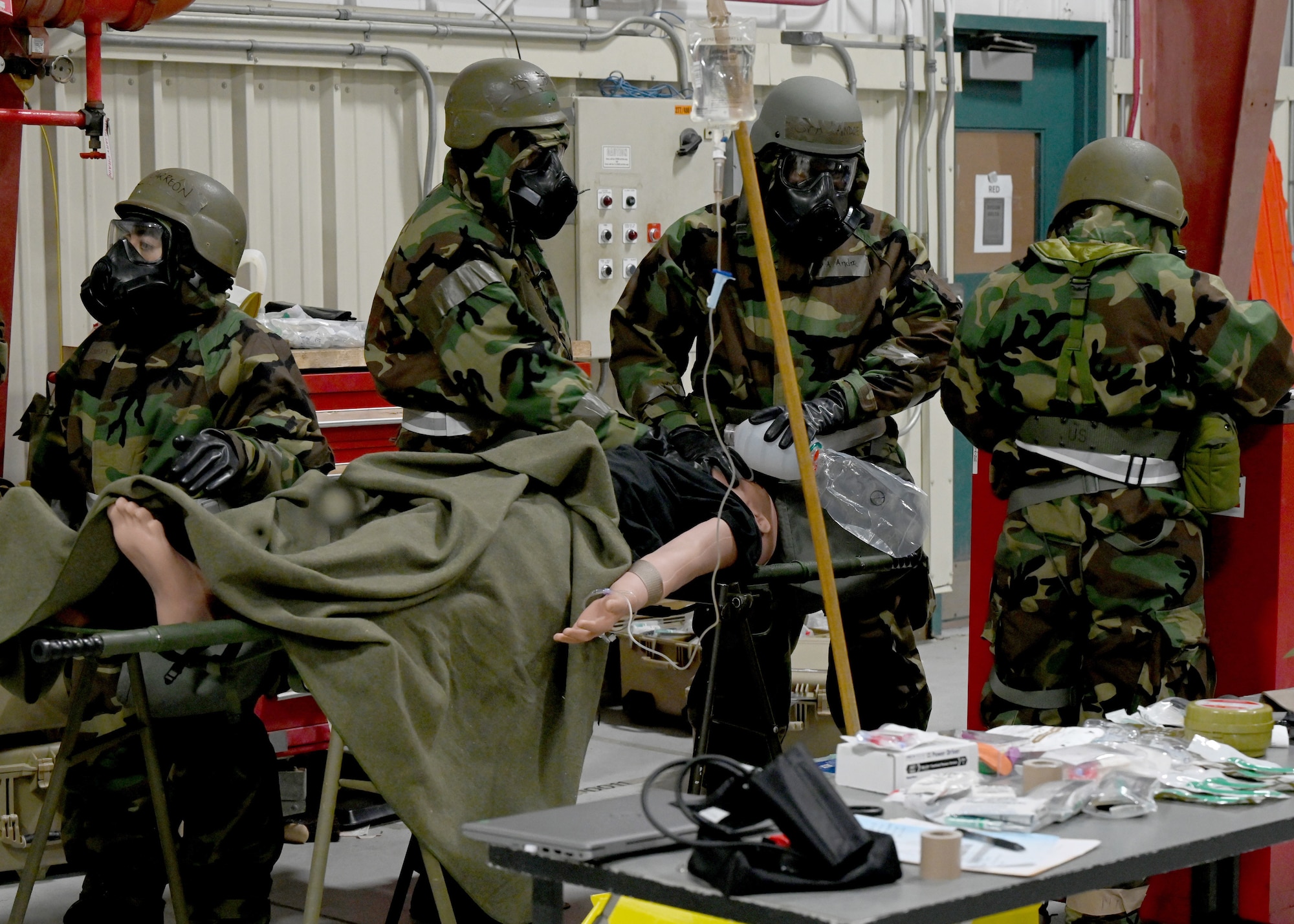 Members of the 106th Medical Group of the 106th Rescue Wing, donned in MOPP gear, persist in treating a simulated motor vehicle accident patient during Agile Combat Employment training amid heightened threat levels at Exercise Agile Rage 2024 at F.S. Gabreski Air National Guard Base, Westhampton Beach, New York, on March 2, 2024. The exercise served as vital preparation for Air National Guard units, emphasizing agility, interoperability, and the Agile Combat Employment (ACE) concept to ensure Airmen were adaptable and ready for any operational challenge. (U.S. Air National Guard photo by Staff Sgt. Kevin J. Donaldson)