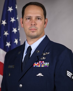 U.S. Air Force Senior Airman Adam Spinner, pararescueman assigned to the 103rd Rescue Squadron of the 106th Rescue Wing,  poses for official photo at F.S. Gabreski Air National Guard Base, Westhampton Beach, New York, Jan. 17, 2024. Spinner,  a resident of Westhampton Beach, was selected as the top Airman of the year for 2023 for the New York Air National Guard and the northeast. (U.S. Air National Guard photo by Capt. Cheran A. Campbell)