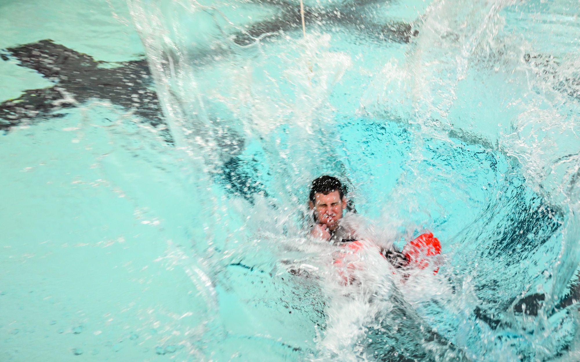 Capt. Thomas Lavelle, a pilot with the 757th Airlift Squadron, is pulled through the water by a parachute cord during water survival training on April 7, 2024, at Youngstown State University, Ohio.