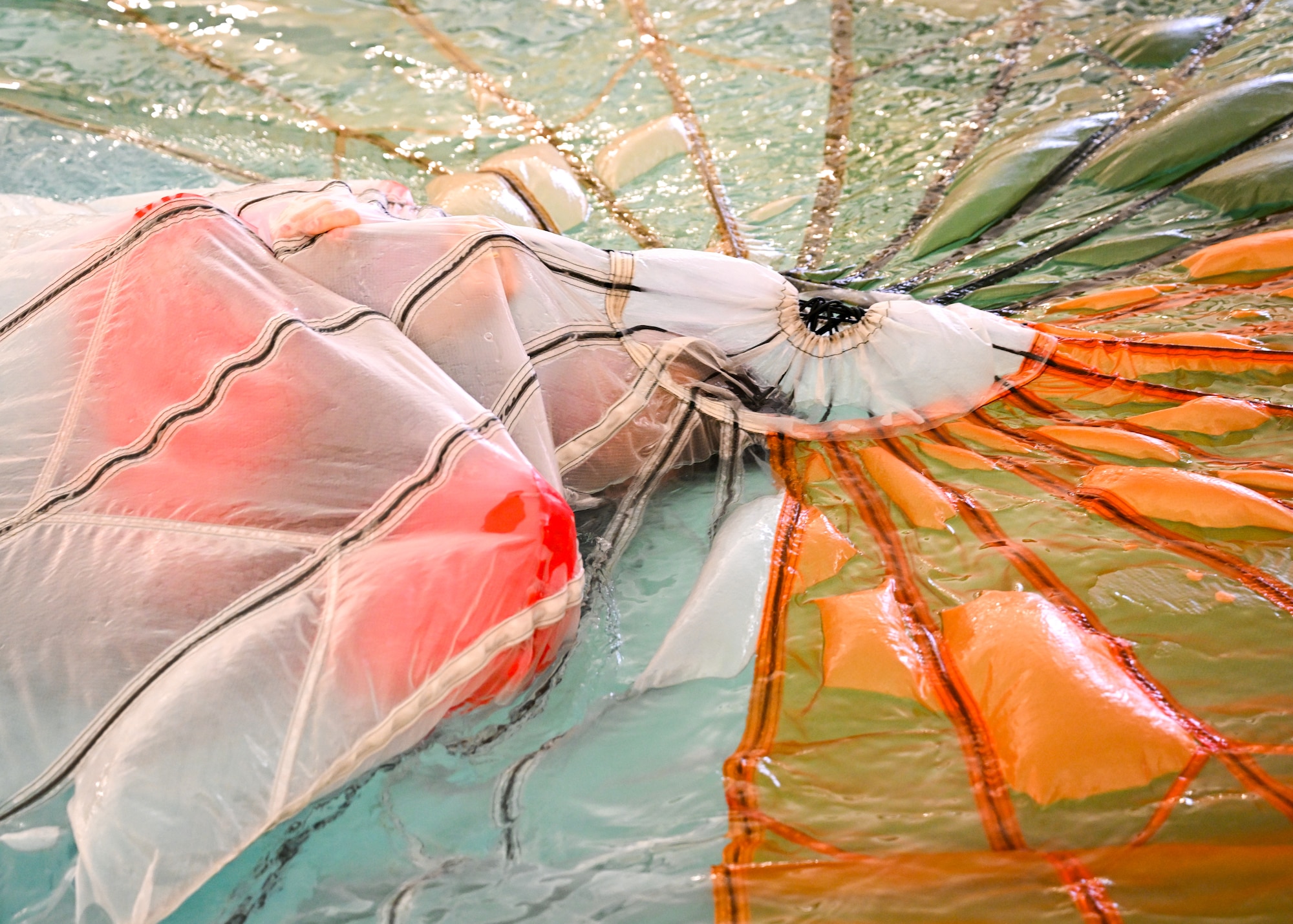A Reserve Citizen Airmen assigned to the 910th Operations Group tries to escape from a parachute during water survival training on April 7, 2024, at Youngstown State University, Ohio.
