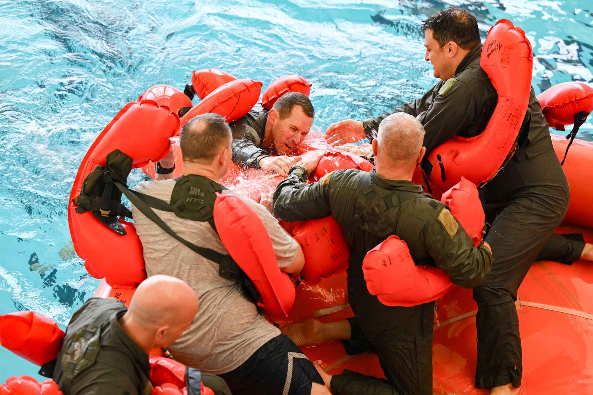 Lt. Col. Steven Stroney, the director of operations with the 757th Airlift Squadron, climbs into a 20-person life raft during water survival training on April 7, 2024, at Youngstown State University, Ohio.