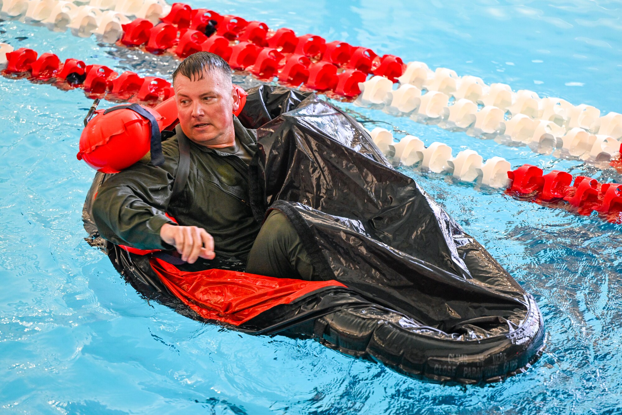 Master Sgt. Joseph Bender, a loadmaster with the 757th Airlift Squadron, floats in a one-person life raft during water survival training on April 7, 2024, at Youngstown State University, Ohio.