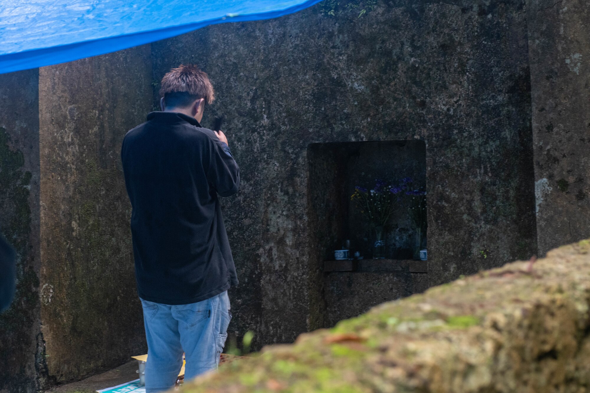 An Okinawan prays at his family’s tomb during Shimi at Kadena Air Base, Japan, April 7, 2024. Shimi is the time of year when Okinawan families come together to clean tombs, offer food and pray to their ancestors. (U.S. Air Force photo by Senior Airman Cedrique Oldaker)