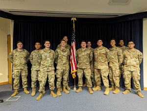 Service members stand during graudation