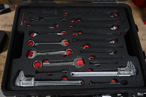 A group of tools sits in a newly made foam toolbox insert