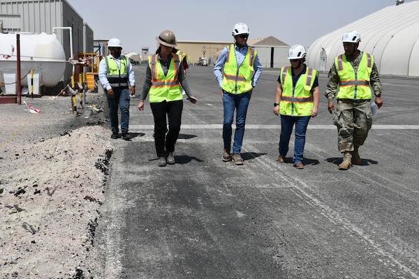 U.S. Army Col. Mohammed Z. Rahman, U.S. Army Corps of Engineers Transatlantic Expeditionary District commander (center), along with district engineers and the regional safety chief, discuss ongoing progress during a site visit at Camp Buehring, Kuwait, Apr. 8, to review the Udairi Landing Zone Transition Repair project, demonstrating USACE’s dedication to maintaining operational excellence and ensuring project success.