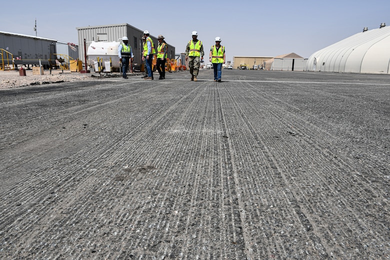 U.S. Army Col. Mohammed Z. Rahman, U.S. Army Corps of Engineers Transatlantic Expeditionary District commander (center), along with district engineers, review construction progress during a site visit at Camp Buehring, Kuwait, Apr. 8, to review the Udairi Landing Zone Transition Repair project, demonstrating USACE’s dedication to maintaining operational excellence and ensuring project success.