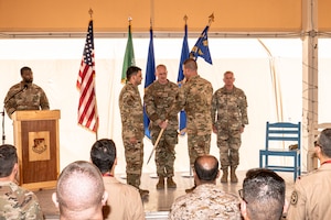 U.S. Air Force Brig. Gen. Quaid Quadri relinquished command of the 378th Air Expeditionary Wing to Col. Seth Spanier during a change of command ceremony at an undisclosed location, in the Central Command area of responsibility, April 6, 2024. Spanier served as the 7th Bomb Wing Commander out of Dyess Air Force Base and has been selected to lead the second rotation under the new Expeditionary Air Base model. The new XAB model shifts the construct of Air Expeditionary Wings from all active, reserve and guard components into force elements centered upon Mission Generation, Command and Control, and the establishment of an operating base. (U.S. Air Force courtesy photo)