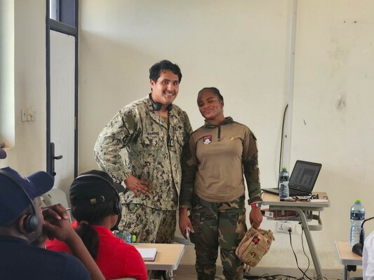 U.S. Navy Hospital Corpsman 1st Class Marcos Ramirez, assigned to Naval Mobile Construction Battalion (NMCB) 11, left, and Ghana Army Pvt.  Kape Apeweh, assigned to the Ghana Naval Training Command (NAVTRAC) Medical Clinic teach first-aid skills to fisheries inspectors onboard NAVTRAC in Nutekpor-Sogakope in the Volta Region of Ghana, Feb. 26, 2024. The training was held as part of a Visit, Board, Search and Seizure (VBSS) course led by the United Nations Office of Drugs and Crime (UNODC) Global Maritime Crime Programme (GMCP). NMCB 11, assigned to the TWENTY SECOND Naval Construction Regiment, is forward deployed across the U.S. Naval Forces Europe-Africa area of operations, in support of U.S. Sixth Fleet maritime operations to defend U.S., allied, and partner interests. (Courtesy Photo)
