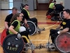 Spc. Brooke Jader "meets the hit" during wheelchair rugby camp at Ft. Belvoir.