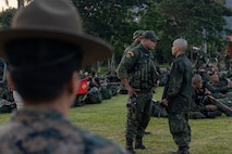 U.S. Marine Corps Master Sgt. Anggie Acosta, a chief instructor with Drill Instructor School, Recruit Training Regiment, Marine Corps Recruit Depot San Diego, observes Corpo de Fuzileiros Navais (Brazilian Marine Corps) Master Sgt. Ademir Marciel, a Fuzileiros Navais drill instructor, discipline his recruit during a Recruit Training Subject Matter Expert Exchange at Centro de Instrução Almirante Milcíades Portela Alves, Brazil, on April 4, 2024.The SMEE aims to enhance the training frameworks and leadership skills necessary for the successful integration of female recruits into the Brazilian Marine Corps. Additionally, the exchange fosters a bilateral partnership, enabling both nations to share best practices and innovations in military training and operational readiness. (U.S. Marine Corps photo by Lance Cpl. David Intriago)