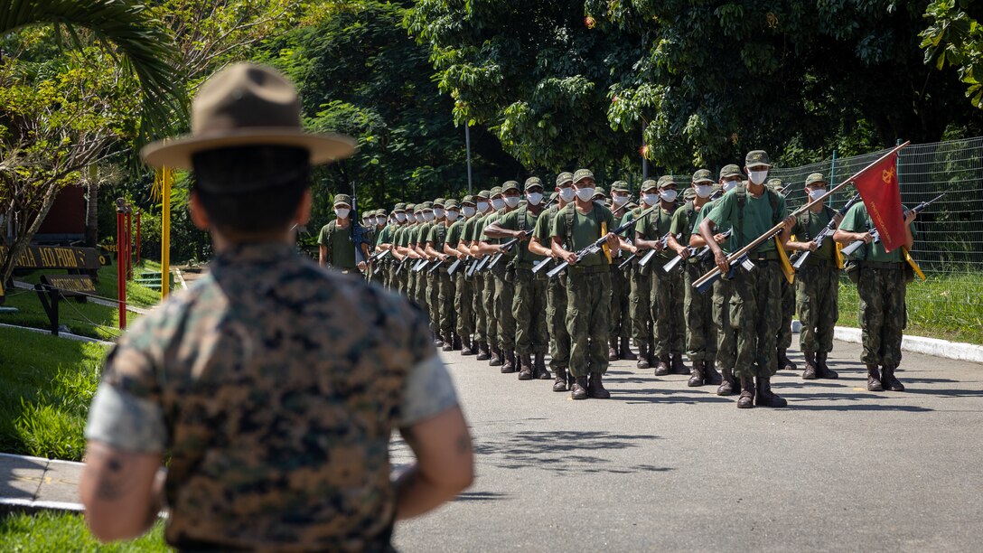 U.S. Marine Corps Master Sgt. Anggie Acosta, a chief instructor at Drill Instructor School, Recruit Training Regiment, Marine Corps Recruit Depot San Diego, observes Corpo de Fuzileiros Navais (Brazilian Marine Corps) recruits drill during a Recruit Training Subject Matter Expert Exchange at Centro de Instrução Almirante Milcíades Portela Alves, Brazil, on April 4, 2024. The SMEE aims to enhance the training frameworks and leadership skills necessary for the successful integration of female recruits into the Brazilian Marine Corps. Leaders from Marine Corps Recruit Depot San Diego visited their Fuzileiros Navais counterparts to share best practices and lessons learned from U.S. Marine Corps recruit training integration. (U.S. Marine Corps photo by Lance Cpl. David Intriago)