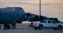 A Defender from the 5th Security Forces Squadron guards a B-52H Stratofortress on the flight line during Exercise Prairie Vigilance/Bayou Vigilance 24-3 at Minot Air Force Base, North Dakota, April 8, 2024. Prairie Vigilance serves to assure Allies and partners that the U.S. is ready to execute nuclear operations and global strike anytime, anywhere, in order to deter and, if necessary, respond to strategic attack. (U.S. Air Force photo by Airman 1st Class Luis Gomez)