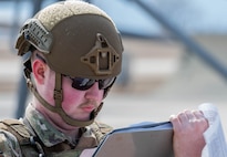 Airman 1st Class Addison Thode, 5th Security Forces Squadron defender, checks paperwork during Prairie Vigilance 24-3 at Minot Air Force Base, North Dakota, April 7, 2024. Exercises such as Prairie Vigilance ensure Airmen stay proficient in a variety of key operational skills. (U.S. Air Force photo by Airman 1st Class Kyle Wilson)