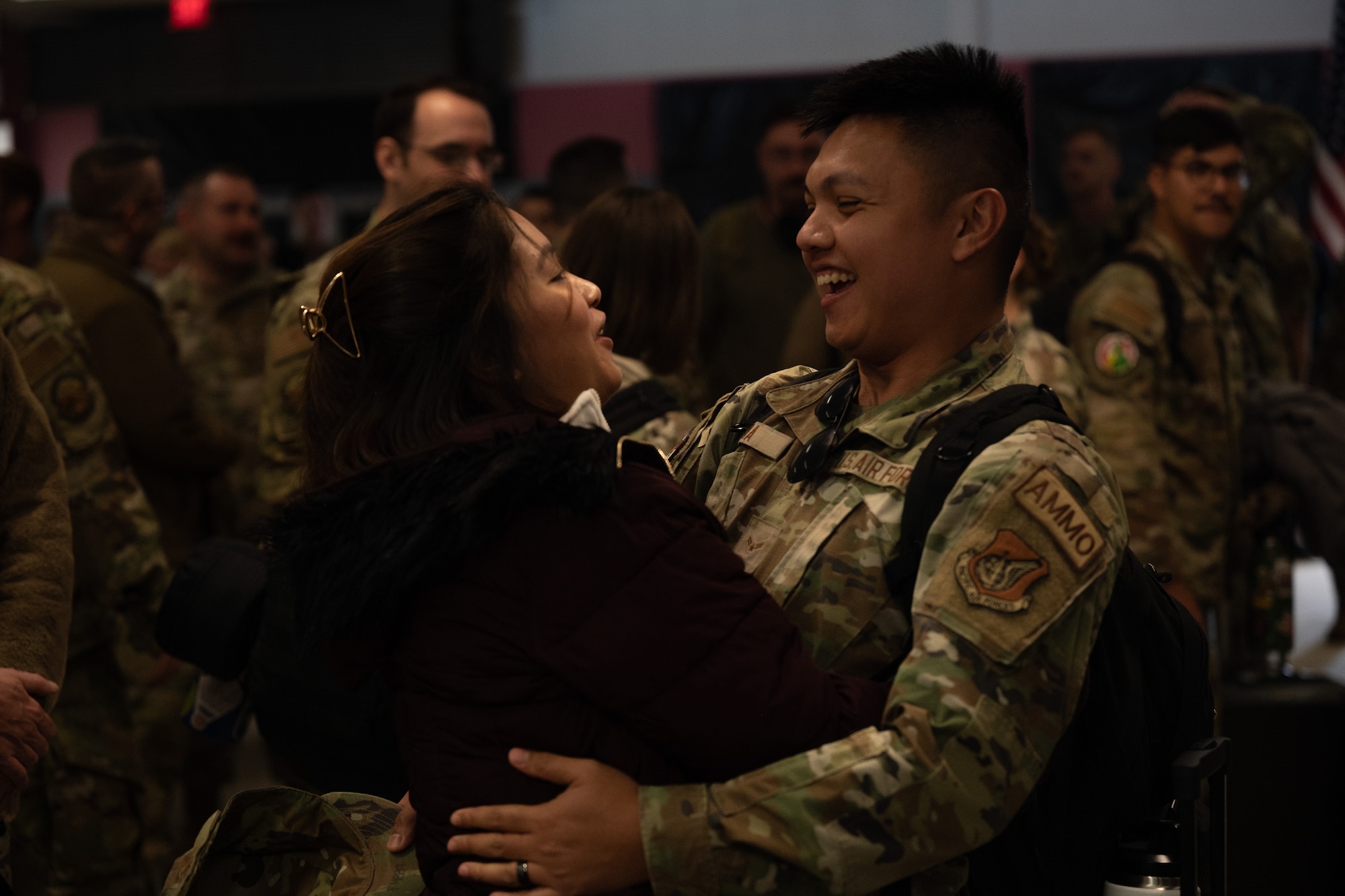 A returning Airman hugs his wife.