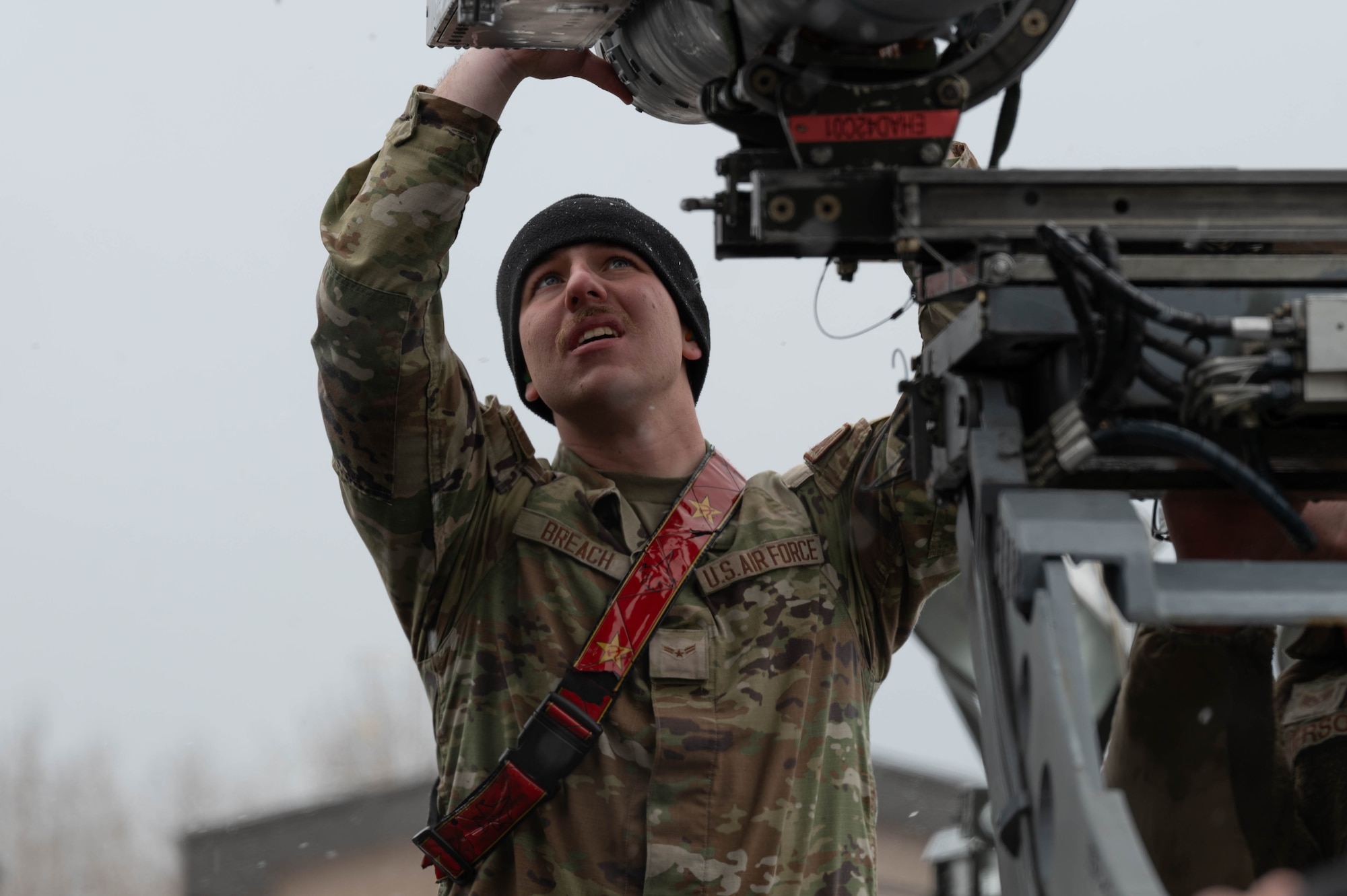 U.S. Air Force Airman 1st Class Levi Breach, 18th Fighter Generation Squadron load crew team member, positions a piece of armament on a fighter jet during a load competition at Eielson Air Force Base, Alaska, April 5, 2024.