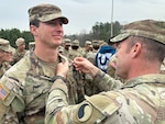 Maj. Josh Favaro, executive officer of the Virginia National Guard’s Fredericksburg-based 229th Brigade Engineering Battalion, 116th Infantry Brigade Combat Team receives the Expert Soldier Badge from Sgt. Maj. Justin Walkup, the 116th Infantry Brigade Combat Team operations sergeant major, March 15, 2024 at Fort Walker, Virginia. The Expert Soldier Badge is a special skills badge awarded to Soldiers who have completed testing and do not serve in the Infantry, Special Forces or Medical Branches. Testing for the ESB consists of 30 tasks- Weapon Lane Tasks, Medical Lane Tasks, Patrol Lane Tasks, and five unit-level missions essential tasks chosen by the commander, as well as a 12-mile road march, a land navigation test and the Expert Physical Fitness Assessment.