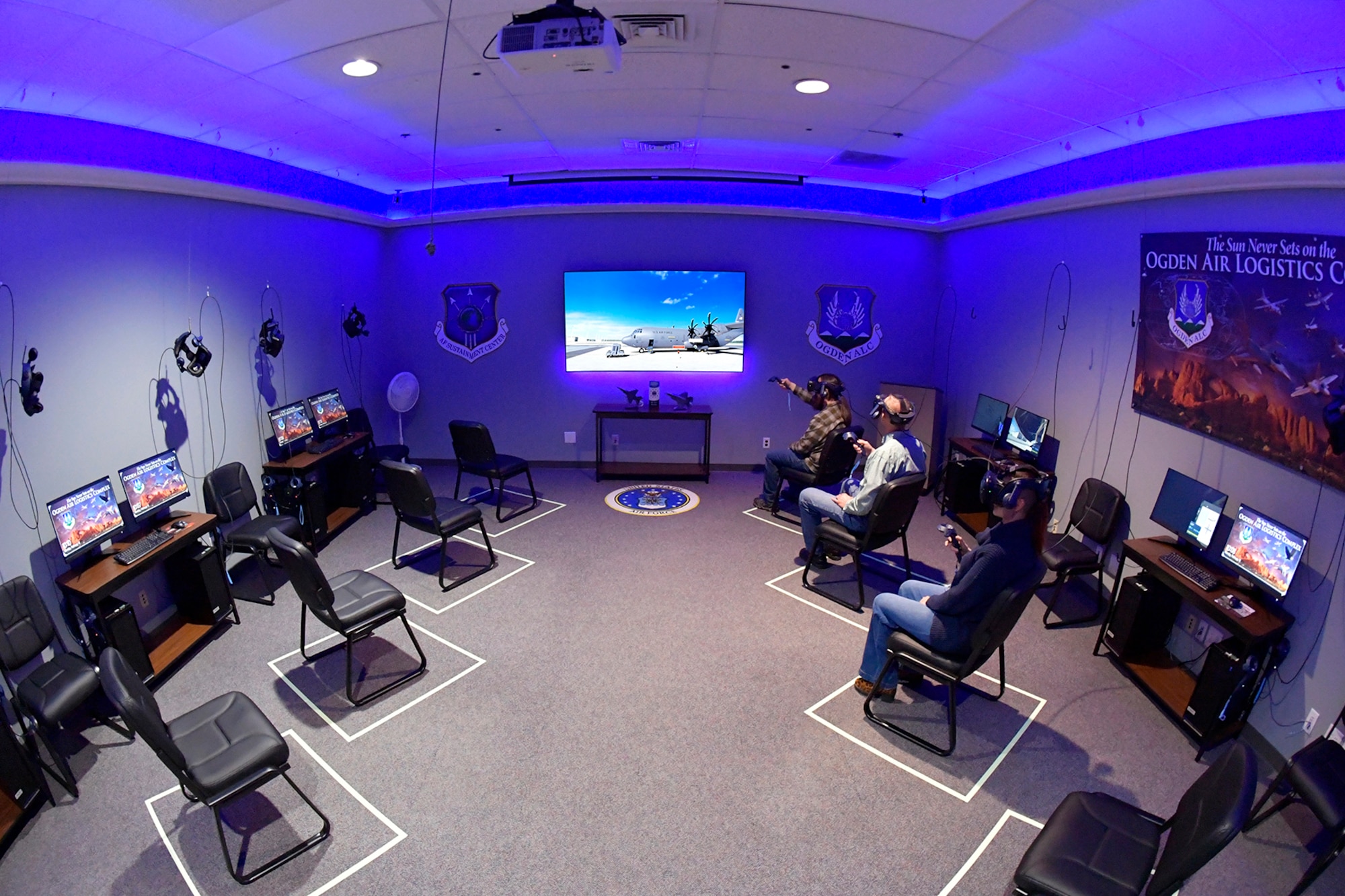 (Left to right) Austin Herrera, Training Specialist, John Sowder, Chief of Maintenance Training Instruction, and Cristina Woodward, Training Specialist, demonstrate the Ogden Air Logistics Complex Training Branch’s virtual reality training program in a state-of-the-art immersive classroom Feb. 12, 2024, at Hill Air Force Base, Utah. This innovative program within the Ogden ALC caters to both new hires and veteran workforce. (U.S. Air Force photo by Todd Cromar)
