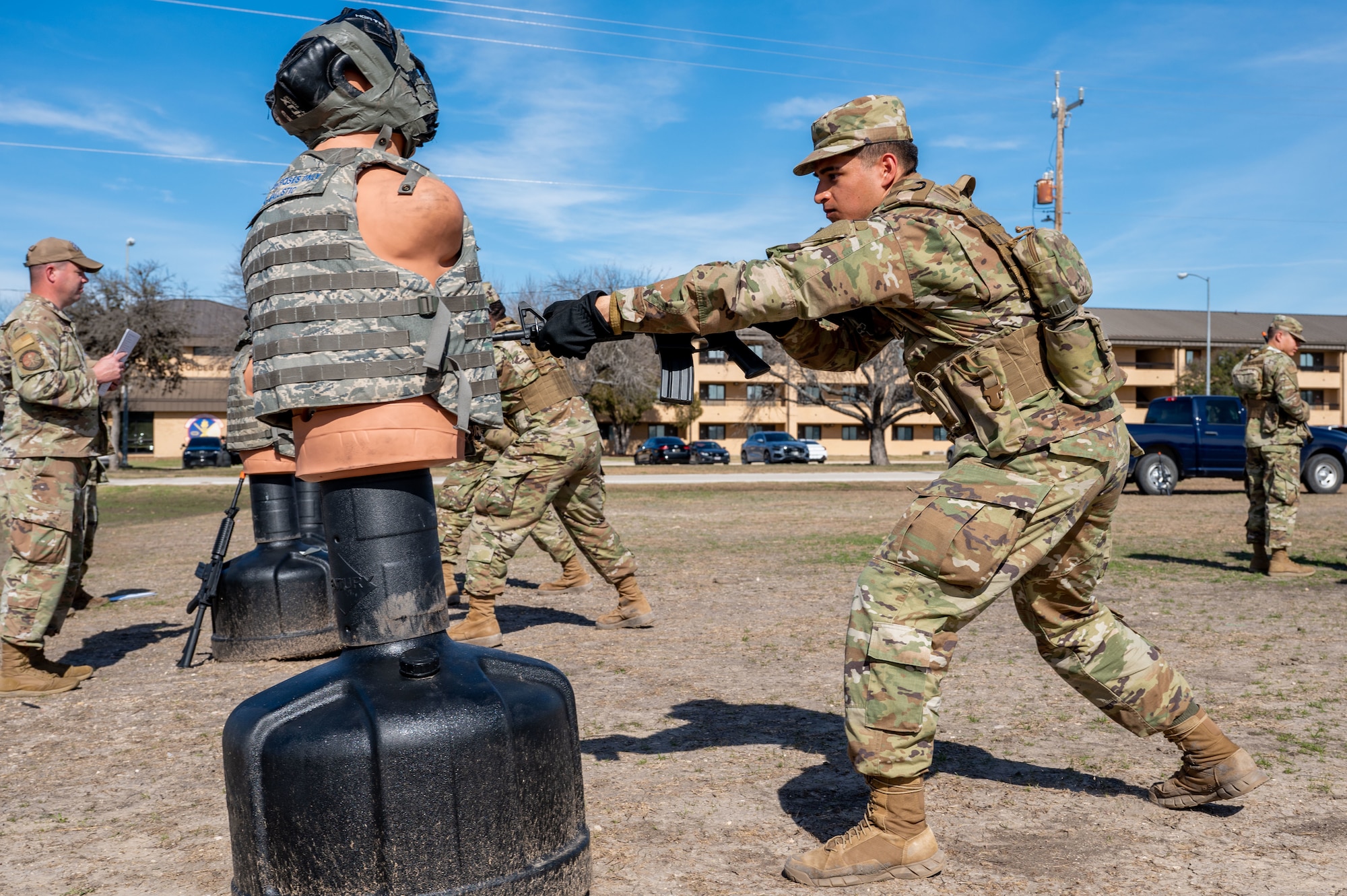 A Security Forces technical training student strikes a dummy during rifle-fighting training at Joint Base San Antoino-Lackland, Texas, Jan. 30, 2024. Joint Base San Antoino-Chapman Annex, Texas, Jan. 22, 2024. The 343rd Training Squadron is optimizing training to ensure Defenders are equipped with the skills and knowledge needed to tackle evolving threats in a modern era. The 343 TRS Security Forces technical training is one of the key components in the Defender Next initiative, where the career field is undertaking the largest shift in the schoolhouse in over two decades.  (U.S. Air Force photo by Vanessa R. Adame)
