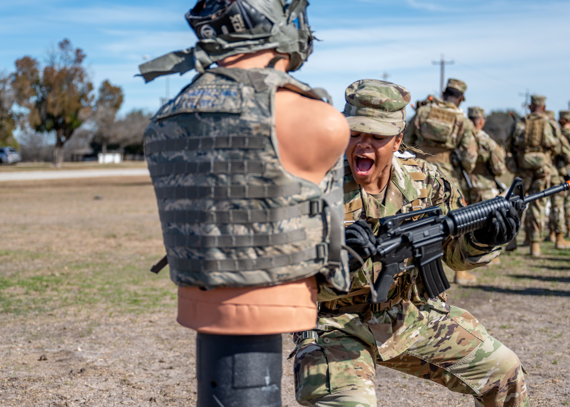 A Security Forces training student reacts as she grips her weapon during rifle-fighting training at Joint Base San Antonio-Lackland, Texas, Jan. 30, 2024. The 343rd Training Squadron is optimizing training to ensure Defenders are equipped with the skills and knowledge needed to tackle evolving threats in a modern era. The 343 TRS Security Forces technical training is one of the key components in the Defender Next initiative, where the career field is undertaking the largest shift in the schoolhouse in over two decades.  (U.S. Air Force photo by Vanessa R. Adame)