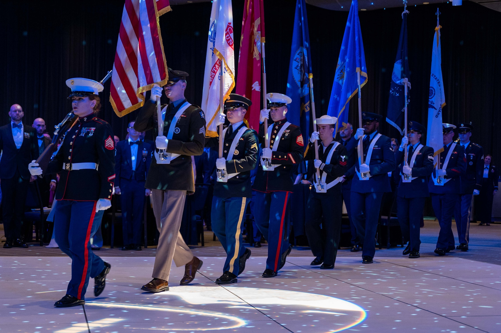 The Aerospace Data Facility - Colorado, Color Guard, march at opening ceremony of the Buckley Ball at the Denver Center for the Performing Arts, Denver, Colorado, April 6, 2024. The Buckley Ball was the first event of its kind at Buckley Space Force Base, to include total force personnel from all branches, marking a historic occasion. (U.S. Space Force photo by Airman 1st Class Joshua Hollis)