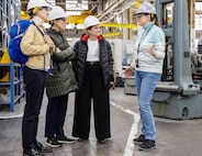 Felicienne Griffin, superintendent, Shop 31, Inside Machinists, leads Lori Tauber, Angelique Bellmer-Krembs and Cie Nicholson, founding members of "The Band of Sisters," on a tour of Building 431, March 28, 2024, during a special Women's History Month visit to Puget Sound Naval Shipyard & Intermediate Maintenance Facility in Bremerton, Washington.