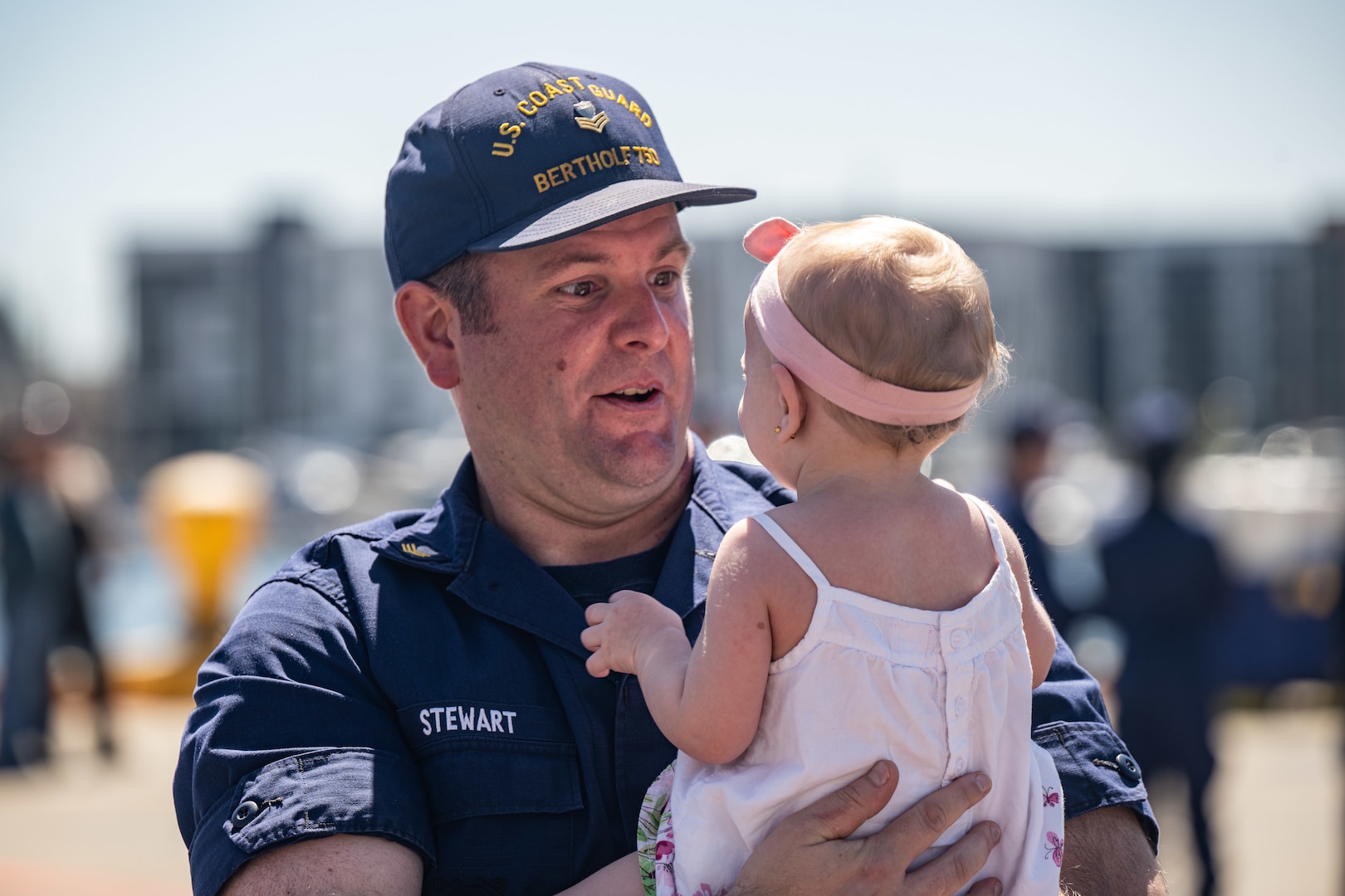 U.S. Coast Guard Petty Officer 1st Class Chase Stewart, an Electrician’s Mate assigned to the Coast Guard Cutter Bertholf (WMSL 750) greets his family at the cutter's return to home port on Coast Guard Base Alameda, Calif., following a 98-day patrol in the Indo-Pacific region, April 8, 2024. The Cutter Bertholf deployed to the Indo-Pacific to advance relationships with ally and partner nations to build a more stable, free, open and resilient region with unrestricted, lawful access to the maritime commons.​ (U.S. Coast Guard Photo by Petty Officer 3rd Class Hunter Schnabel)