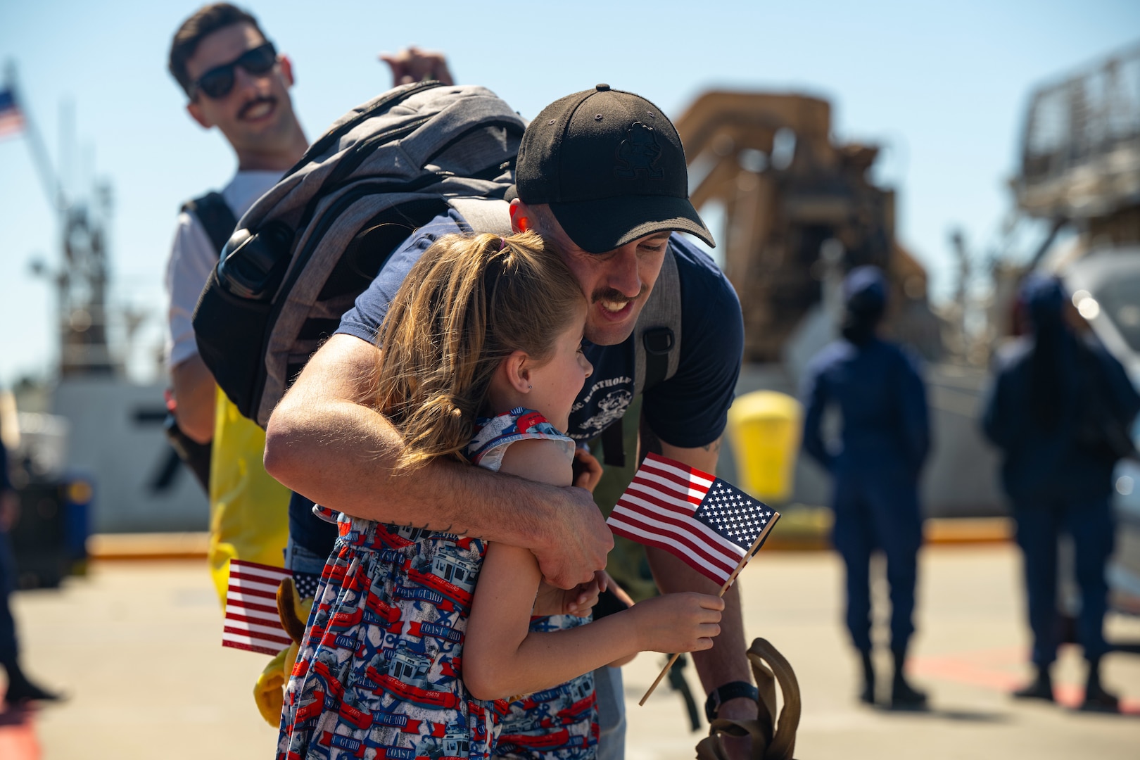 A crew member assigned to the Coast Guard Cutter Bertholf (WMSL 750) greets his family at the cutter's return to home port on Coast Guard Base Alameda, Calif., following a 98-day patrol in the Indo-Pacific region, April 8, 2024. The U.S. Coast Guard has operated in the Indo-Pacific for more than 150 years, and the Service is increasing efforts through targeted patrols with our National Security Cutters, Fast Response Cutters, and other activities conducted in support of Coast Guard missions to enhance our partnerships. (U.S. Coast Guard Photo by Petty Officer 3rd Class Hunter Schnabel)